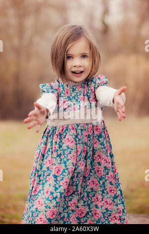 Portrait of little girl wearing robe floral design dans la nature d'automne Banque D'Images