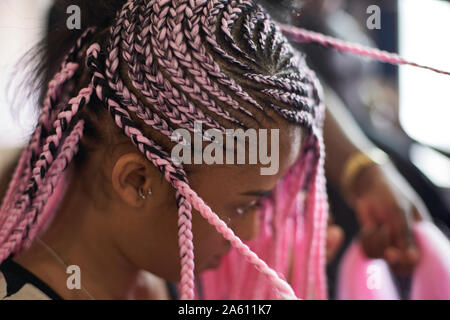 Jeune femme aux tresses roses, close-up Banque D'Images