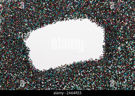 Paillettes holographiques sur fond noir avec vide espace vide dans le centre. Banque D'Images