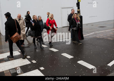 Après de fortes pluies, les londoniens et les visiteurs à pied le long de Long Acre, Covent Garden, le 24 octobre 2019, à Westminster, Londres, Angleterre. Banque D'Images