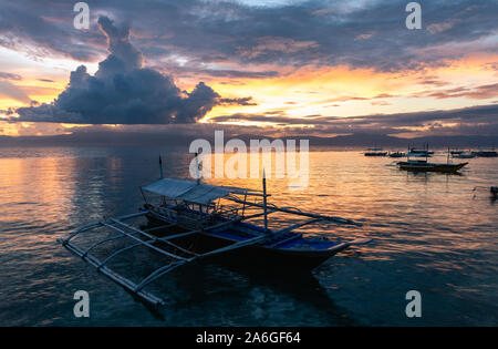 Bateaux à Panagsama Beach pendant le coucher du soleil, Moalboal, Cebu, Philippines. Banque D'Images