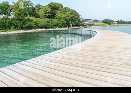 Les gens à pied par le pont de l'infini (Den Uendelige Bro) en forme de cercle - jetée en bois construit sur un littoral de la Baie d'Aarhus sur une plage de Varna/Ballehage Beach, créé par l'architecte Niels Povlsgaard Gjødes et Johan sont vus à Aarhus, Danemark, le 30 juillet 2019 © Michal Fludra / Alamy Live News