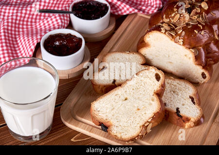 La vie toujours avec gâteau de Noël tricoté ou pâtisserie avec raisins secs et amandes. Les tranches de vieux bois table avec des verres à confiture de fruits, verre de Banque D'Images