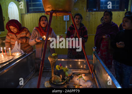 Srinagar, Inde. 27 Oct, 2019. Les dévots prient à l'intérieur d'un temple pendant le festival.Diwali est la réunion de cinq jours de la fête des Lumières, célébrée par des millions d'hindous, sikhs et Jaïns à travers le monde. Diwali qui pour certains coïncide également avec la récolte et fêtes de fin d'année, est un festival de nouveaux commencements et le triomphe du bien sur le mal, et la lumière sur les ténèbres. Credit : SOPA/Alamy Images Limited Live News Banque D'Images