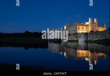 Une beauté à Leeds Castle reflétées dans le lac, illuminé la nuit. Banque D'Images