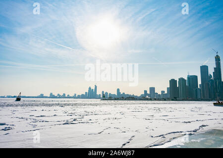 Une bouée dans un lac gelé Michigan à Chicago avec le soleil et la ligne d'horizon après un Vortex polaire Banque D'Images