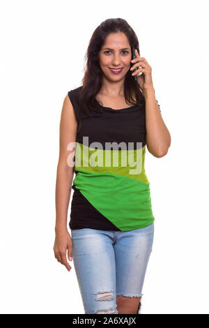 Studio shot of Persian woman smiling while talking on phone Banque D'Images