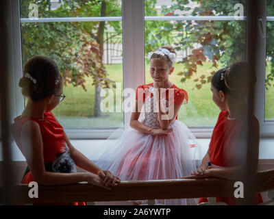 Vitebsk-Belarus. L'Est de l'Europe-September 19, 2019 : trois filles de moins de 15 ans habillé en robe de soirée rouge vif communiquer lors d'un b Banque D'Images