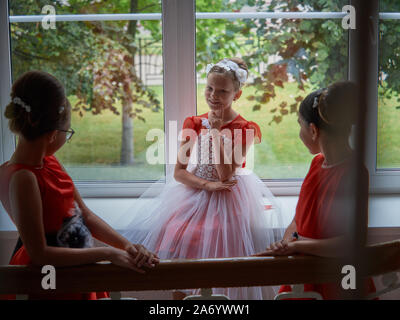 Vitebsk-Belarus. L'Est de l'Europe-September 19, 2019 : trois filles de moins de 15 ans habillé en robe de soirée rouge vif communiquer lors d'un b Banque D'Images