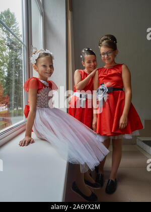 Vitebsk-Belarus. L'Est de l'Europe-September 19, 2019 : trois filles de moins de 15 ans habillé en robe de soirée rouge vif communiquer lors d'un b Banque D'Images