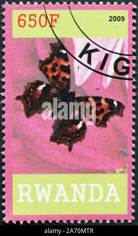 Beau papillon sur timbre-poste du Rwanda Banque D'Images