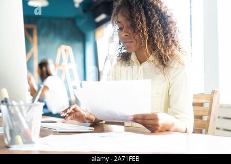 Young african american man au bureau et de travail sur ordinateur portable. Banque D'Images