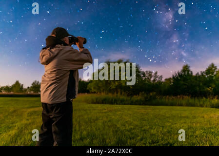 Un des selfies moi observant avec le Celestron SkyMaster 15x70 Jumelles, à la lumière de l'augmentation de la Lune croissante, de la maison le 20 août 2019. Un seul s Banque D'Images