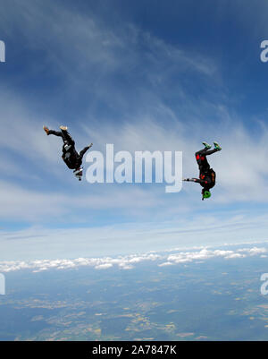 Cette équipe est parachutiste volant autour d'un l'autre dans le ciel bleu et d'avoir du plaisir. Bientôt, ils vont suivre à l'écart et d'ouvrir leurs parachutes enregistrer. Banque D'Images