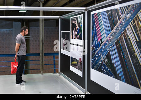 (191031) -- SAO PAULO, le 31 octobre 2019 (Xinhua) -- Une personne affiche des photos au cours de la troisième édition de l'exposition photo mixte Médias BRICS à Sao Paulo, Brésil, le 30 octobre 2019. La troisième édition de l'exposition photo mixte des médias des BRICS s'est ouvert le mercredi ici, avec la présence de représentants des médias du pays membre du groupe -- Brésil, Russie, Inde, Chine et Afrique du Sud. Des dizaines de photographies de 15 entreprises médiatiques grand public des cinq pays ont présenté le développement économique et social, les progrès scientifiques et technologiques, les échanger Banque D'Images