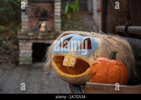 Drôle Spooky Halloween pumpkins, Jack O Lantern sur un vieux piano et d'une cheminée sur l'arrière-plan Banque D'Images