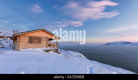 Une maison en bois, de Barents au coucher du soleil à Teriberka, région de Mourmansk, péninsule de Kola. La Russie. Banque D'Images