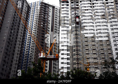 MANDALUYONG CITY, PHILIPPINES - le 29 octobre 2019 : lors d'une grue à tour sur travaux en cours site d'une des tours d'immeuble en copropriété. Banque D'Images