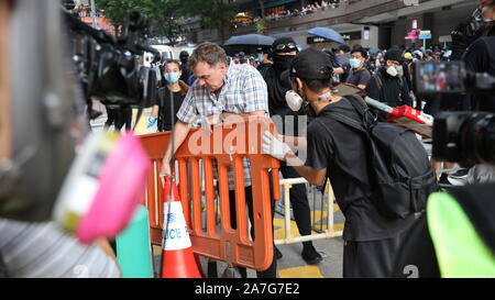 Hong Kong, Chine. 09Th Nov 2019. (191102) -- Hong Kong, le 2 novembre 2019 (Xinhua) -- un homme efface des barricades à Queen's Road East à Hong Kong, Chine du sud, le 2 novembre 2019. Noir vêtue des manifestants ont bloqué les routes illégales et le trafic perturbé au Queen's Road East, le samedi. Un homme a bravé les manifestants illégaux pour effacer les barricades sur la route. (Xinhua) Source : Xinhua/Alamy Live News Banque D'Images