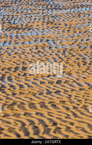 Des modèles dans le sable humide avec des lignes et des lignes de crêtes à marée basse sur une plage de sable sur la côte nord du comté de Norfolk Banque D'Images