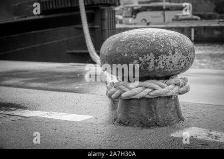 Un navire est attaché avec une corde épaisse d'un bollard dans le port Banque D'Images