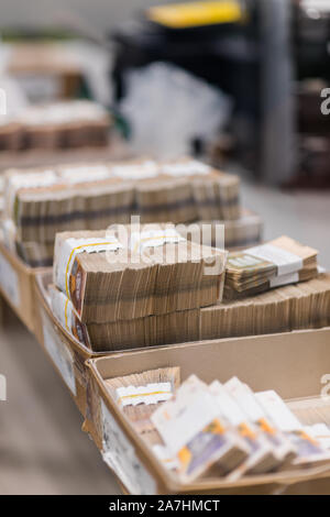 Grande quantité d'argent divisé et triés avec service de bandes et placés dans des boîtes en carton Banque D'Images