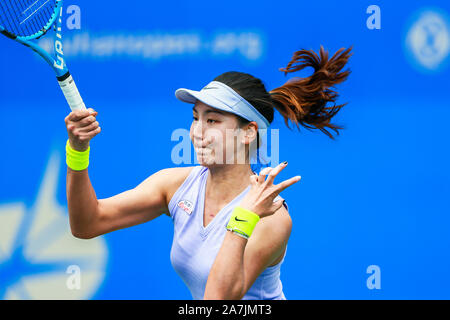 Xinyu Wang de Chine récupère la balle contre Kurumi Nara du Japon à la match de qualification des femmes simple de 2019 WTA Open de Wuhan à Wuhan, 100 Banque D'Images