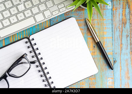 Télévision minimaliste jeter composition de livre, stylo, plante et les verres sur la table en bois Vue de dessus Banque D'Images