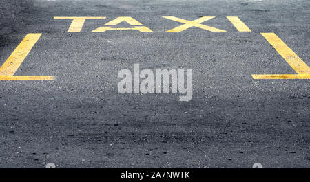 High angle view of yellow taxi sign on road. Banque D'Images