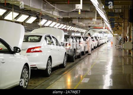 --FILE--Un travailleur chinois assemble des véhicules sur la ligne de montage à une usine automobile à Wuhan, province du Hubei en Chine centrale, 25 octobre 2017. L Banque D'Images