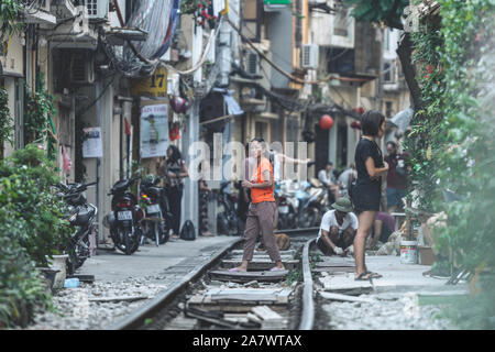 Hanoi, Vietnam - 18 octobre 2019 : les touristes prendre des photos tout en se tenant debout sur la voie ferrée à la rue Train à Hanoi, Vietnam Banque D'Images