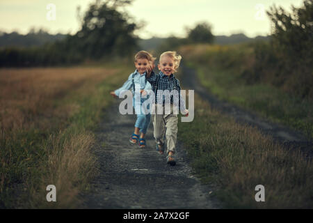 Deux adorables frères d'exécution sur la route de campagne Banque D'Images