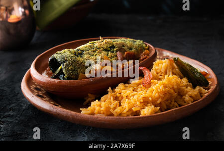 Chilles et chile rellenos accompagné de riz mexicain traditionnel servi dans les plaques d'argile Banque D'Images
