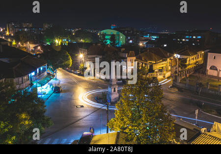 La circulation sur la rue au rond-point dans la ville de Vranje dans la nuit. Banque D'Images