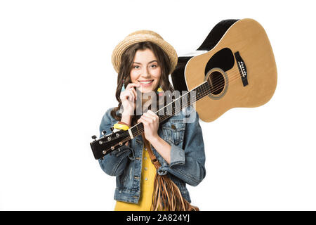 Hippie smiling girl holding acoustic guitar isolated on white Banque D'Images