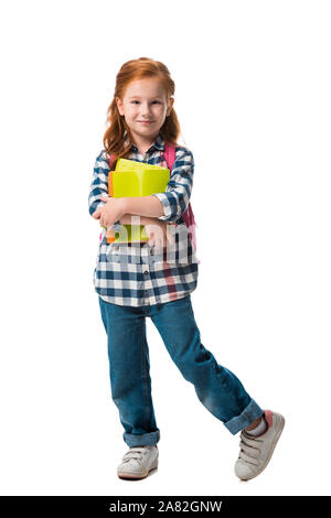 Happy kid en denim jeans holding books isolated on white Banque D'Images
