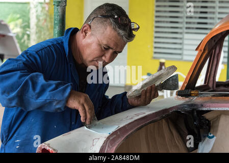 Une voiture cubaine carrossier, travaillant sur une voiture classique dans un petit village dans le garage Valle de Vinales, province de Pinar del Río, à l'ouest de Cuba, Cuba Banque D'Images