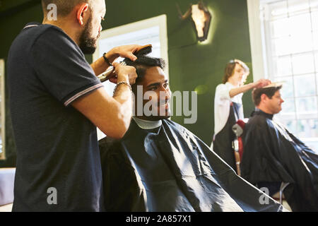 Smiling man coupe au salon de coiffure Banque D'Images