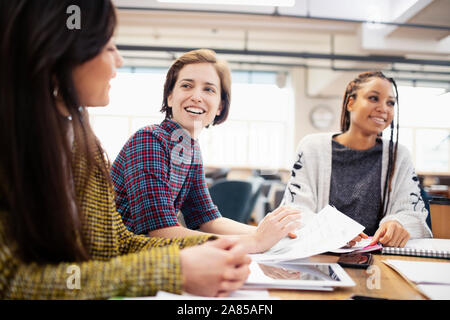 Smiling businesswomen talking in meeting Banque D'Images