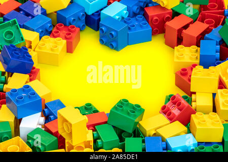 Blocs de construction en plastique coloré briques jouet avec place pour vous les textes et contenu. Banque D'Images