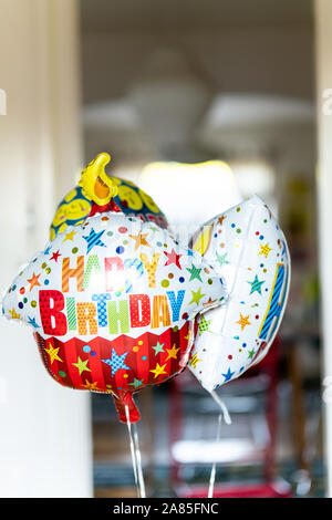 Bouquet de ballons anniversaire pendants devant la porte de l'intérieur Banque D'Images