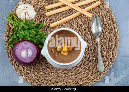 Plat français célèbre, soupe à l'oignon. Oignons caramélisés en stock cuit avec du vin et des herbes, garni de baguette grillées et de fromage et un fini Banque D'Images