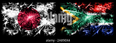 Le Japon, le japonais contre l'Afrique du Sud, d'Afrique Nouvel An fête drapeaux fireworks mousseux fond concept. Combinaison de deux états abstraits des drapeaux. Banque D'Images