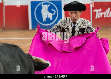 Matador mexicain Curro Vivas présente sa cape pour le taureau comme il se recharge pendant une corrida à la Plaza de Toros à San Miguel de Allende, Mexique. Banque D'Images