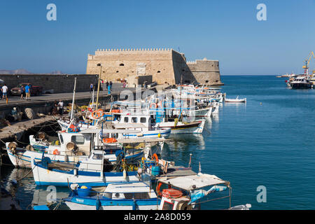 Héraklion, Crète, Grèce. Vue sur le port vénitien, bateaux amarrés en face de la forteresse d'Héraklion. Banque D'Images