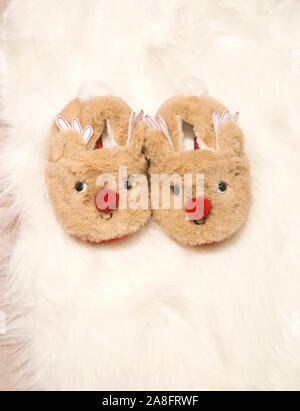 Accueil Enfant chaussons sur un tapis moelleux blanc Banque D'Images