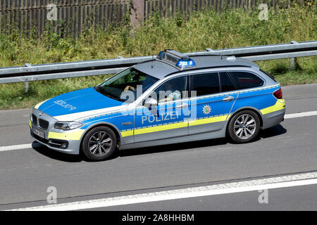 Rhénanie du Nord-Westphalie state police voiture avec éclairage de véhicule d'urgence bleu active sur autoroute. Banque D'Images