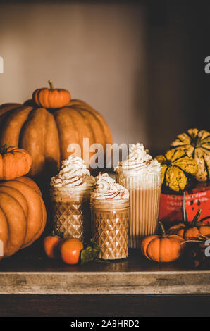 Boire du café latte citrouille garnie de crème fouettée, copy space Banque D'Images