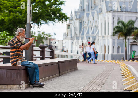 CALI, COLOMBIE - Octobre 2019 : Vieil homme jouant de sa flûte d'obtenir de l'argent à la rivière Boulevard à Cali Banque D'Images