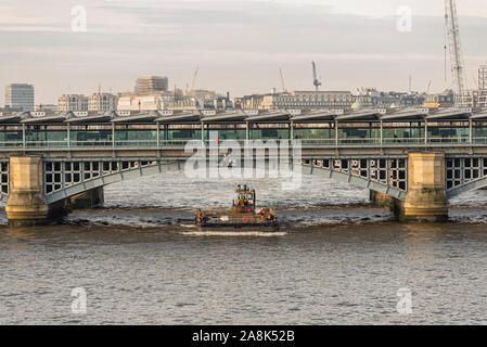 CPBS Marine Tug Shake Dog pousse une barge GPS sur la Tamise. Londres, Royaume-Uni. Trafic fluvial pour les affaires, l'industrie. Skyline de Londres Banque D'Images